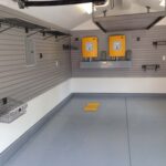 garage with new floors and storage hooks on walls