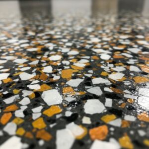 A close-up shot of a high-quality epoxy flooring flake system, showing its texture and color blend